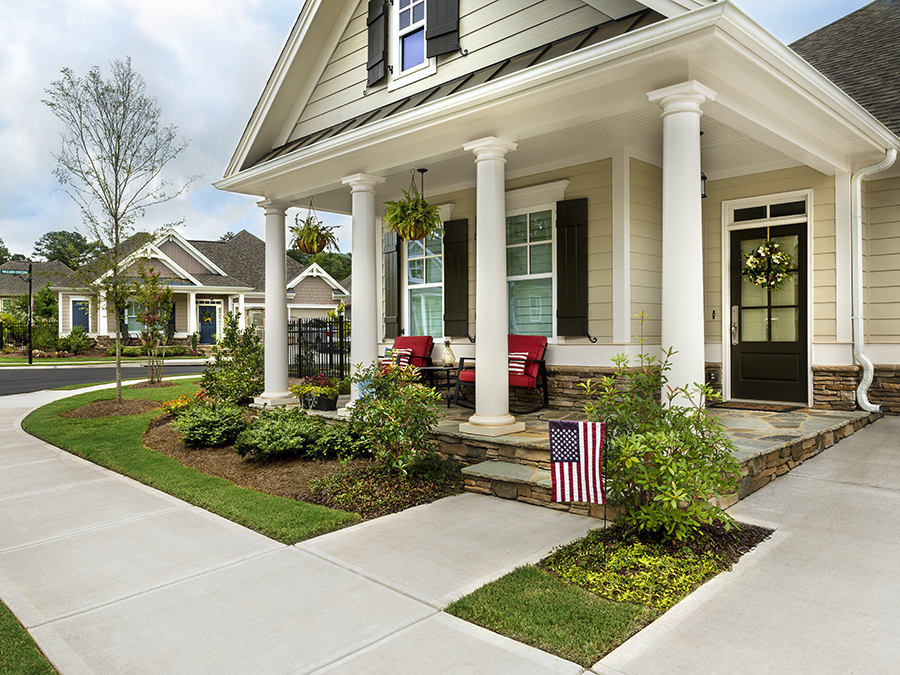 Beautiful home with streetscape in backround and American flag in the yard